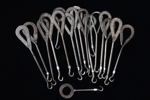 A collection of steel advertising button hooks