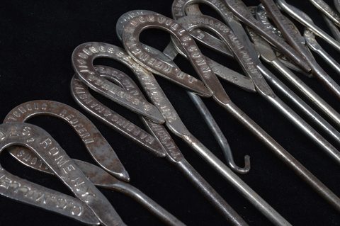 A collection of steel advertising button hooks