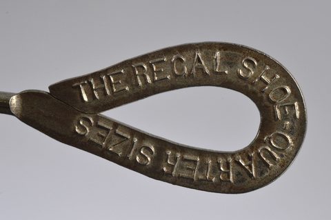 A collection of steel advertising button hooks