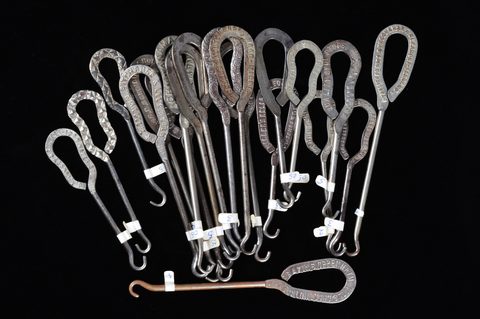 A collection of steel advertising button hooks