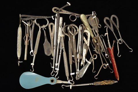 A collection of steel advertising button hooks