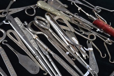 A collection of steel advertising button hooks