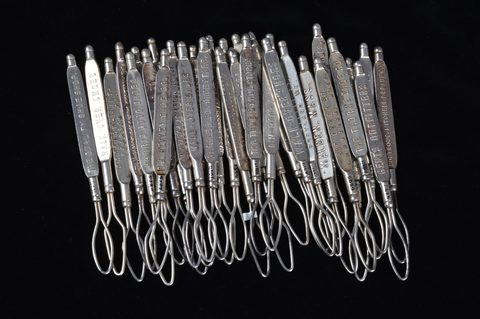 A collection of steel advertising button loops