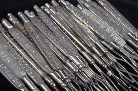 A collection of steel advertising button loops