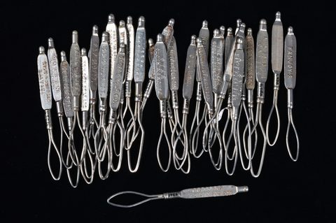 A collection of steel advertising glove button loops