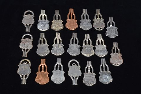 A collection of steel and brass 19th Century folding commemorative or souvenir button hooks