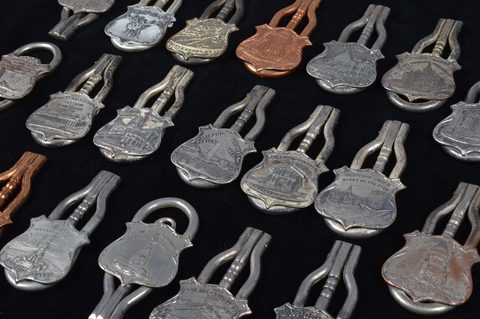 A collection of steel and brass 19th Century folding commemorative or souvenir button hooks
