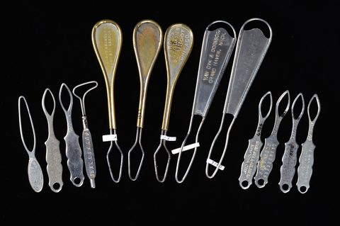 A collection of steel and brass flat button loops
