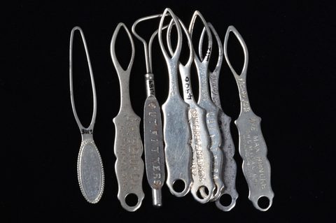 A collection of steel and brass flat button loops