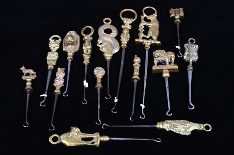 A collection of steel brass handle mounted souvenir and commemorative button hooks