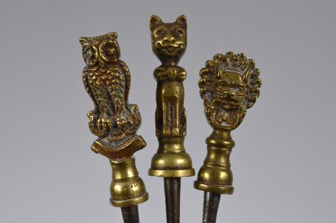 A collection of steel brass handle mounted souvenir and commemorative button hooks