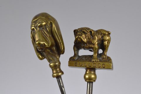 A collection of steel brass handle mounted souvenir and commemorative button hooks