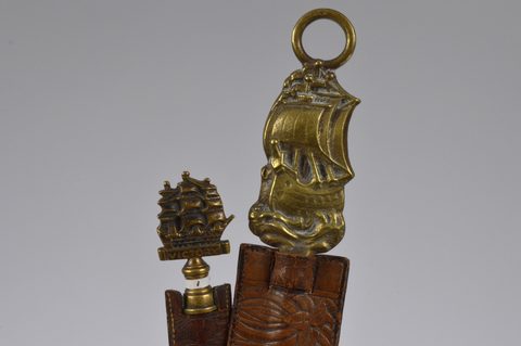 A collection of steel brass handle mounted souvenir and commemorative button hooks