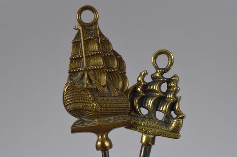 A collection of steel brass handle mounted souvenir and commemorative button hooks