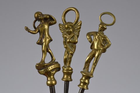A collection of steel brass handle mounted souvenir and commemorative button hooks