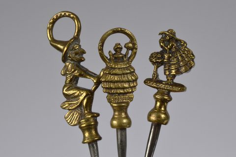 A collection of steel brass handle mounted souvenir and commemorative button hooks