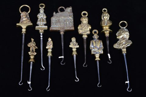 A collection of steel brass handle mounted souvenir and commemorative button hooks