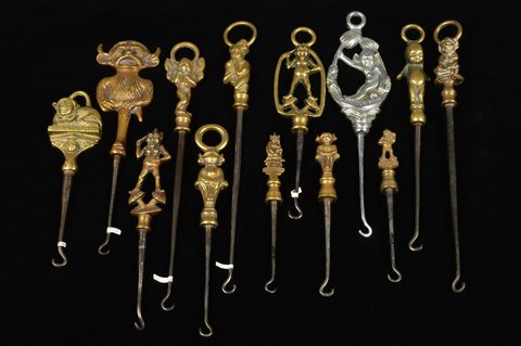 A collection of steel brass handle mounted souvenir and commemorative button hooks
