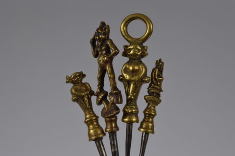 A collection of steel brass handle mounted souvenir and commemorative button hooks