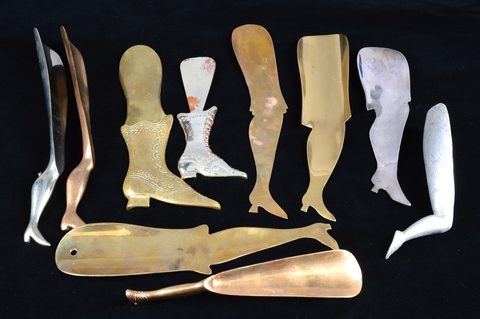 A collection of ten steel and brass boot terminal shoe horns