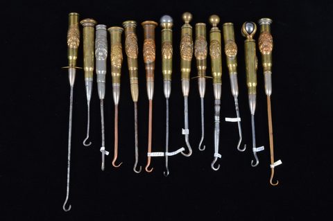 A collection of thirteen trench art Royal Engineers 'Honi soit qui mal y pense' cypher mounted converted shell button hooks
