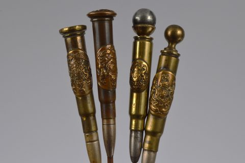 A collection of thirteen trench art Royal Engineers 'Honi soit qui mal y pense' cypher mounted converted shell button hooks