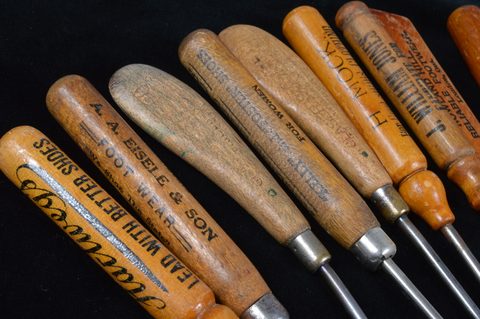A collection of turned and carved wooden handled button hooks