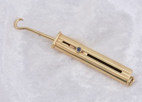 A continental art deco 14k marked slide button hook