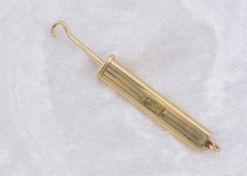 A continental art deco 14k marked slide button hook