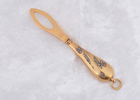 A continental yellow metal diamond set button loop