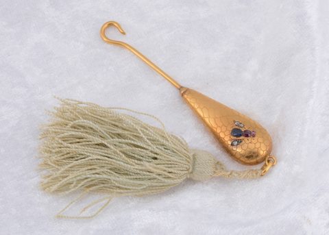 A continental yellow metal gem set button hook