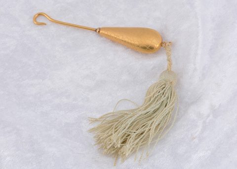 A continental yellow metal gem set button hook
