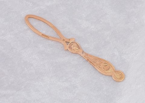 A continental yellow metal loop button hook