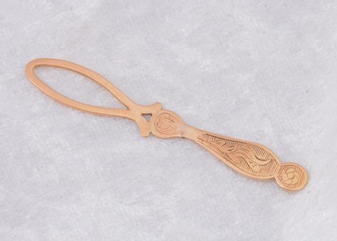 A continental yellow metal loop button hook