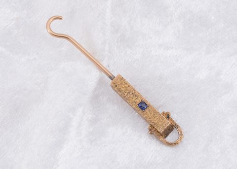 A Victorian gem set yellow metal button hook