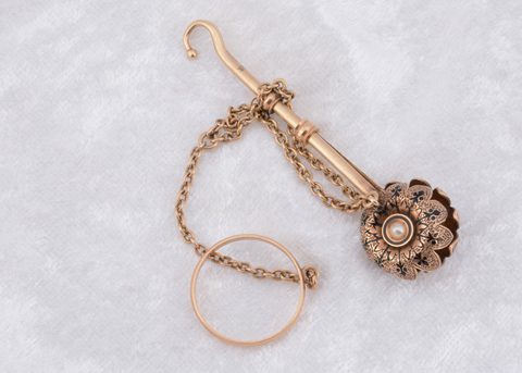 A Victorian yellow metal enamel and seed pearl button hook and handkerchief clasp