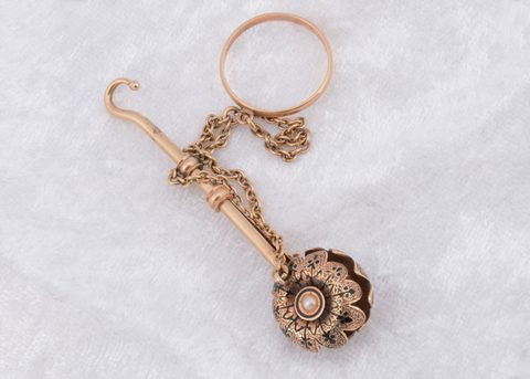 A Victorian yellow metal enamel and seed pearl button hook and handkerchief clasp