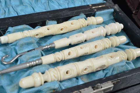 Eight cased Victorian and later bone and resin dressing table sets