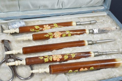 Eight cased Victorian and later bone and resin dressing table sets