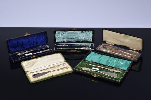 Five cased silver handled button hook and shoehorn sets