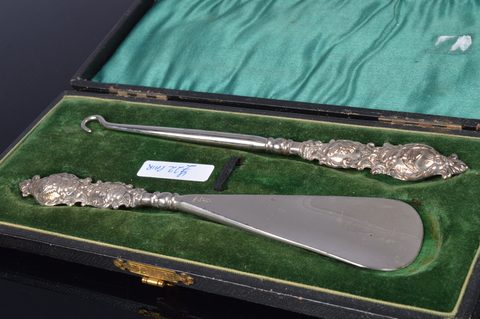 Five cased silver handled button hook and shoehorn sets