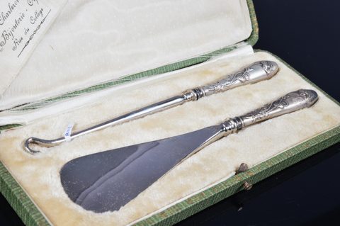 Five cased silver handled button hook and shoehorn sets