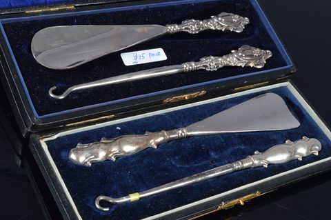 Five cased silver handled button hook and shoehorn sets