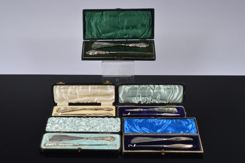 Five cased silver handled button hook and shoehorn sets
