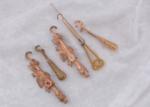 Five gold plated button hook pins and brooches