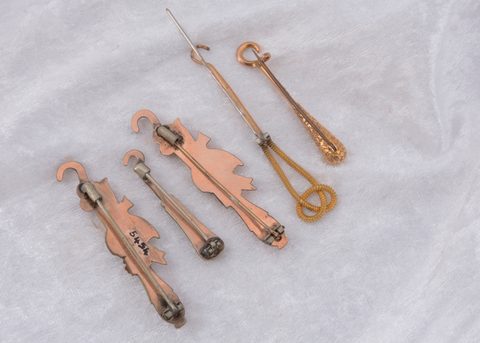 Five gold plated button hook pins and brooches