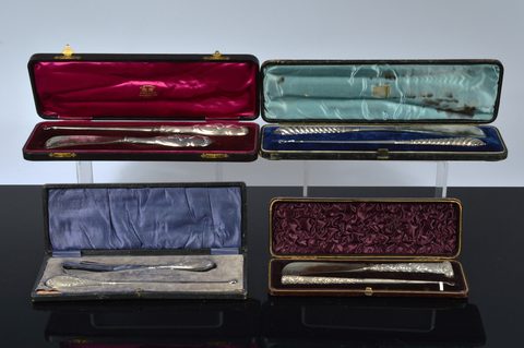 Four cased silver handled button hook and shoehorn sets