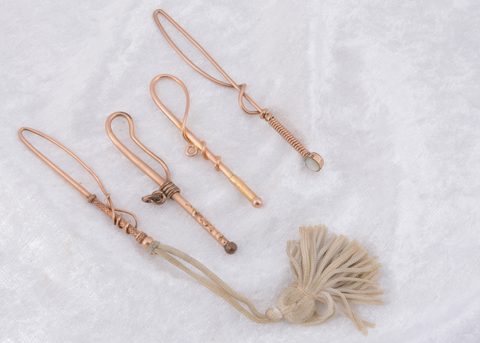Four Edwardian gold plated novelty loop button hooks