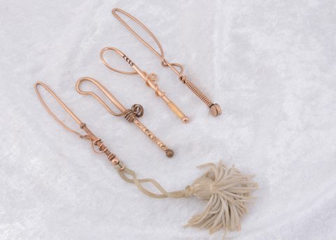 Four Edwardian gold plated novelty loop button hooks