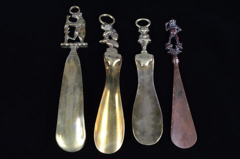 Four heavy brass shoehorns